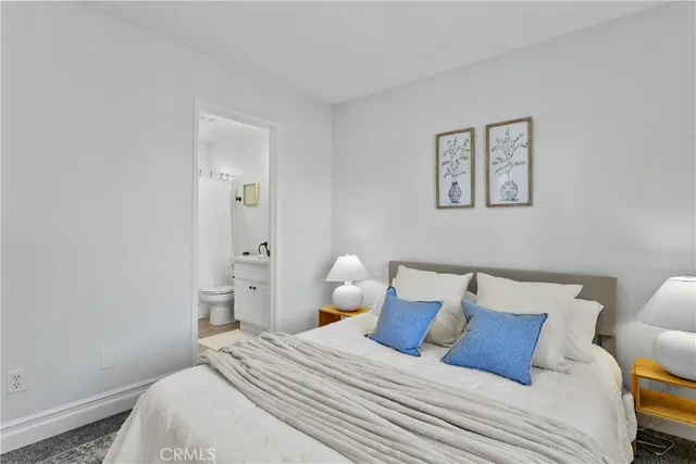 a bedroom with a bed and lamp