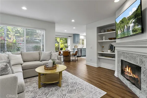 a living room with furniture a fireplace and a flat screen tv