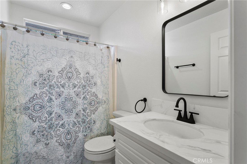 81 Plateau Aliso Viejo, CA 92656 - Photo 23 of 31 a bathroom with a sink toilet a mirror and shower