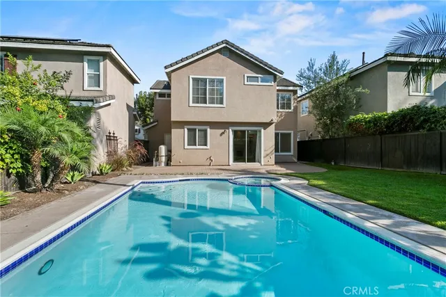 a view of house with a swimming pool
