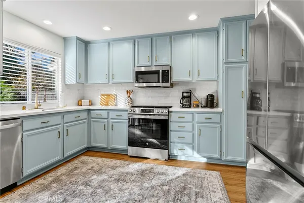 a kitchen with a sink stove and refrigerator