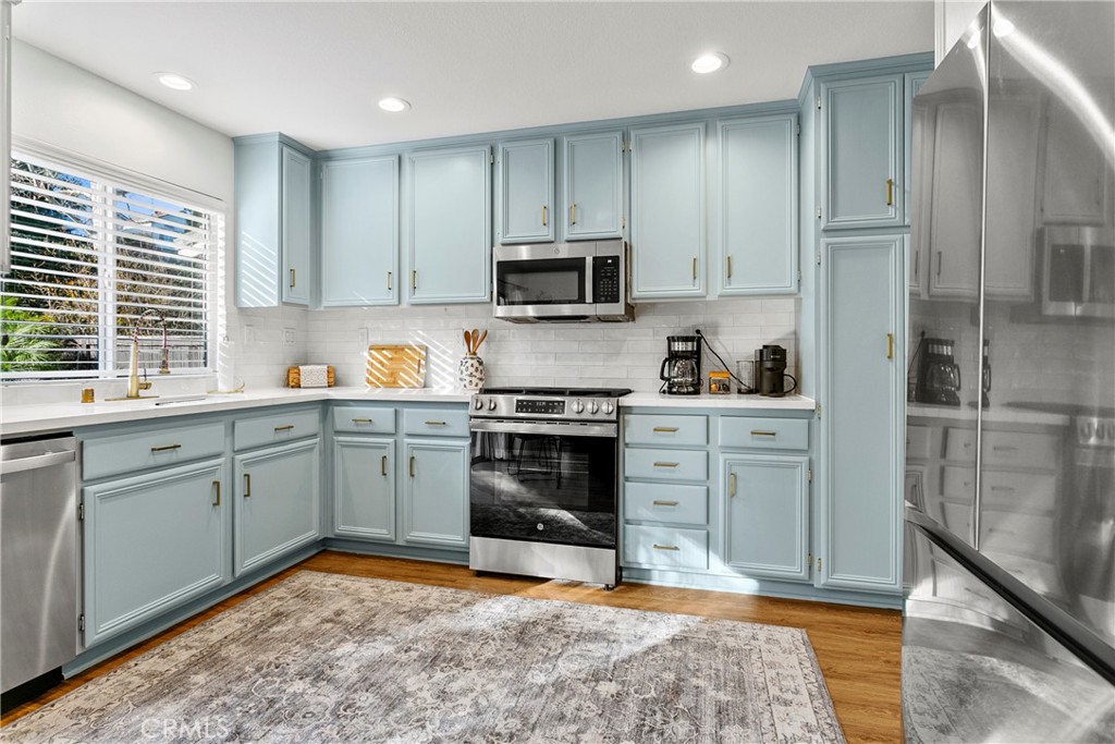 81 Plateau Aliso Viejo, CA 92656 - Photo 5 of 31 a kitchen with a sink stove and refrigerator