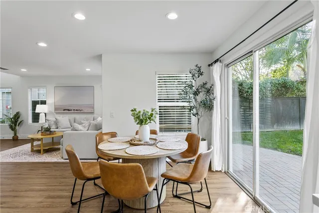 a dining room with furniture window and wooden floor