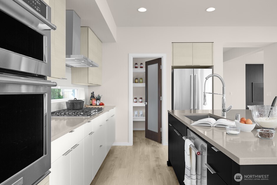 25624 169th Place Southeast Covington, WA 98042 - Photo 6 of 10 a kitchen with a sink dishwasher a stove and a refrigerator with wooden floor