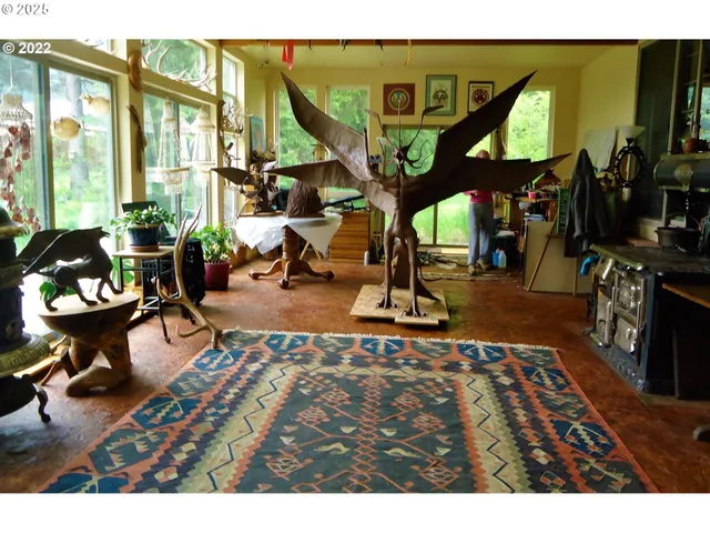 a living room with furniture a rug floor and a large window