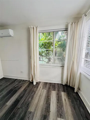 a view of a room with wooden floor and staircase