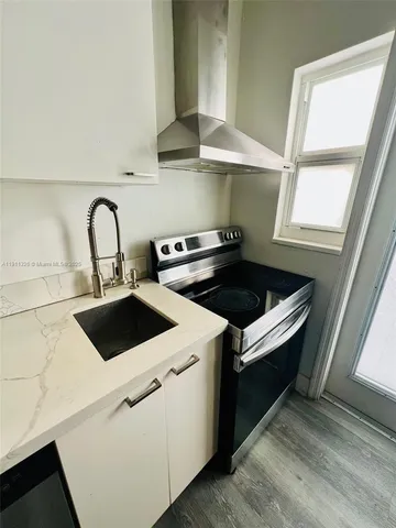 a kitchen with a stove and a sink