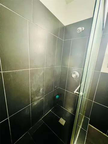 a bathroom with a shower and a sink