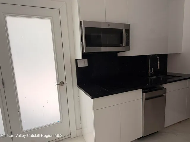a close view of a kitchen with a sink and dishwasher