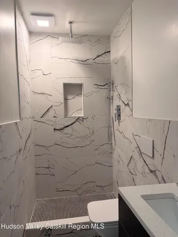 a bathroom with a sink toilet and shower
