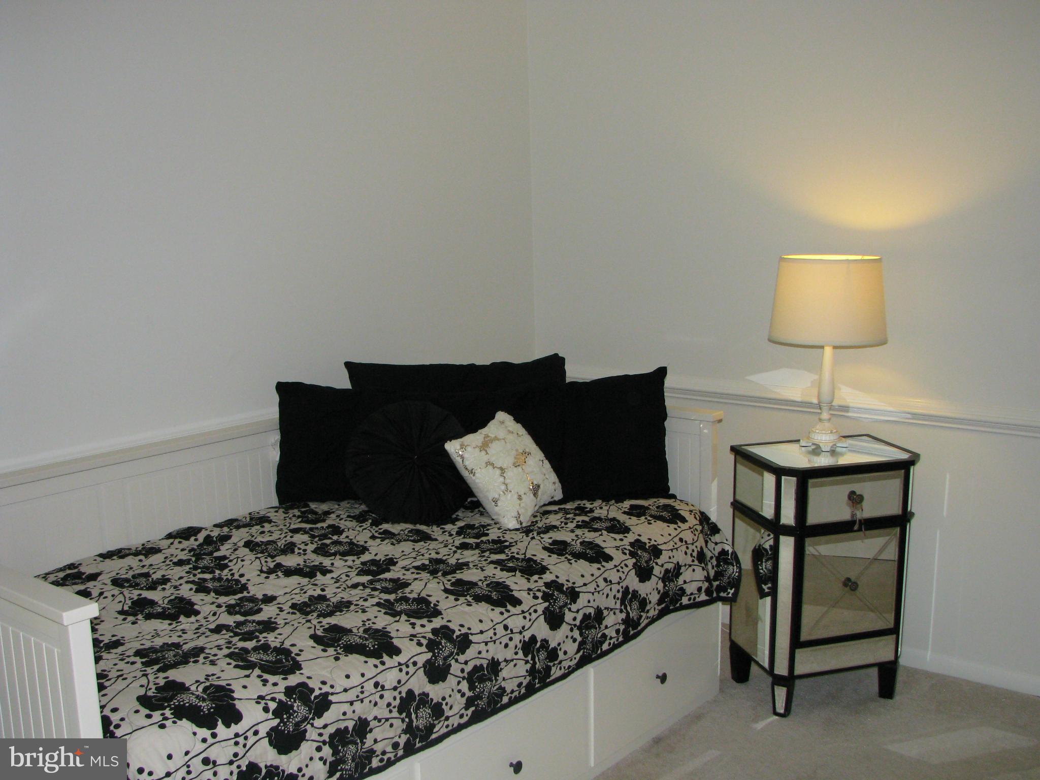 4207 Jackson Mill Road Haymarket, VA 20169 - Photo 15 of 30 a bed sitting in a bedroom next to a lamp