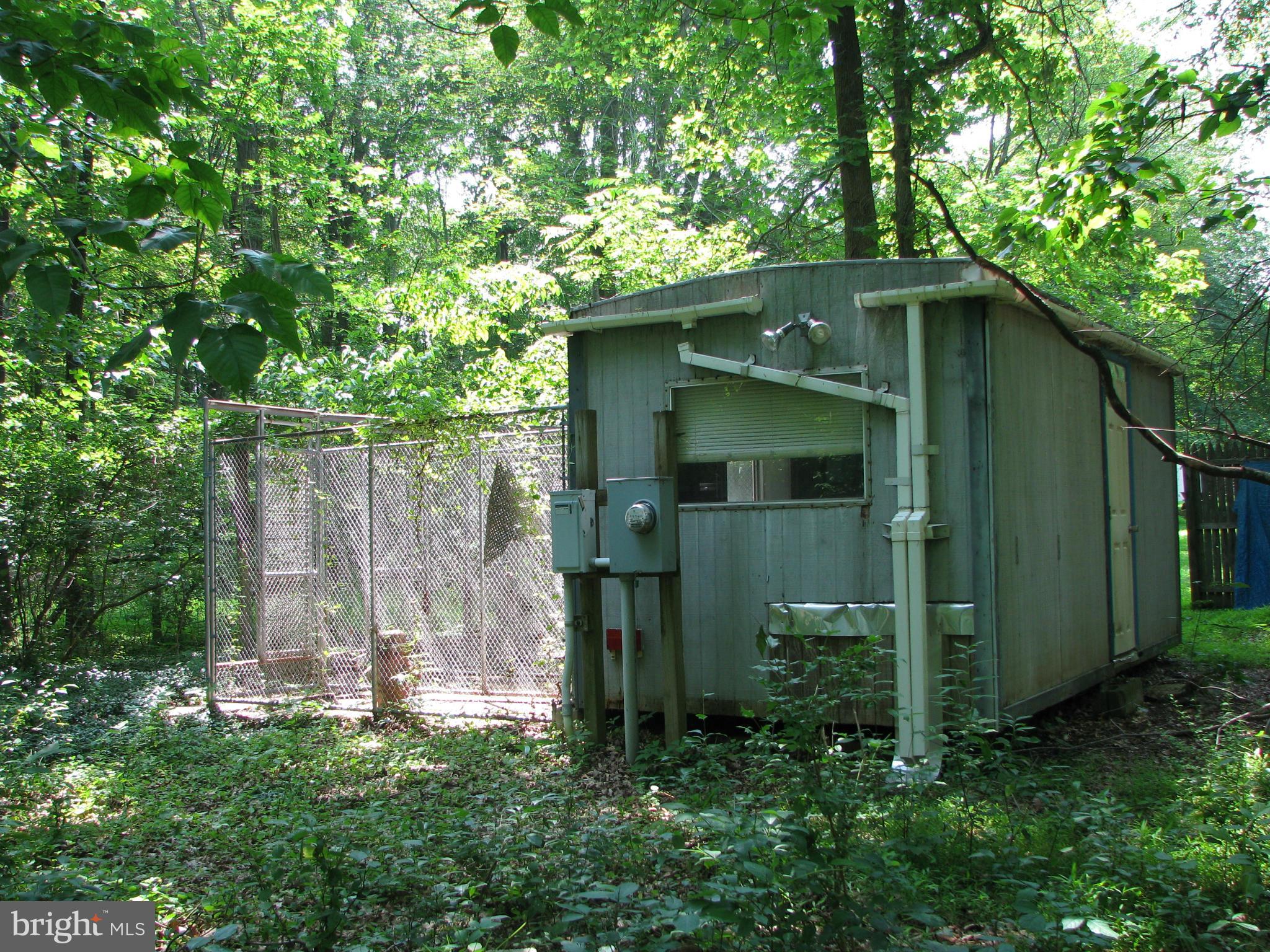 4207 Jackson Mill Road Haymarket, VA 20169 - Photo 27 of 30 a green house with large trees in the background