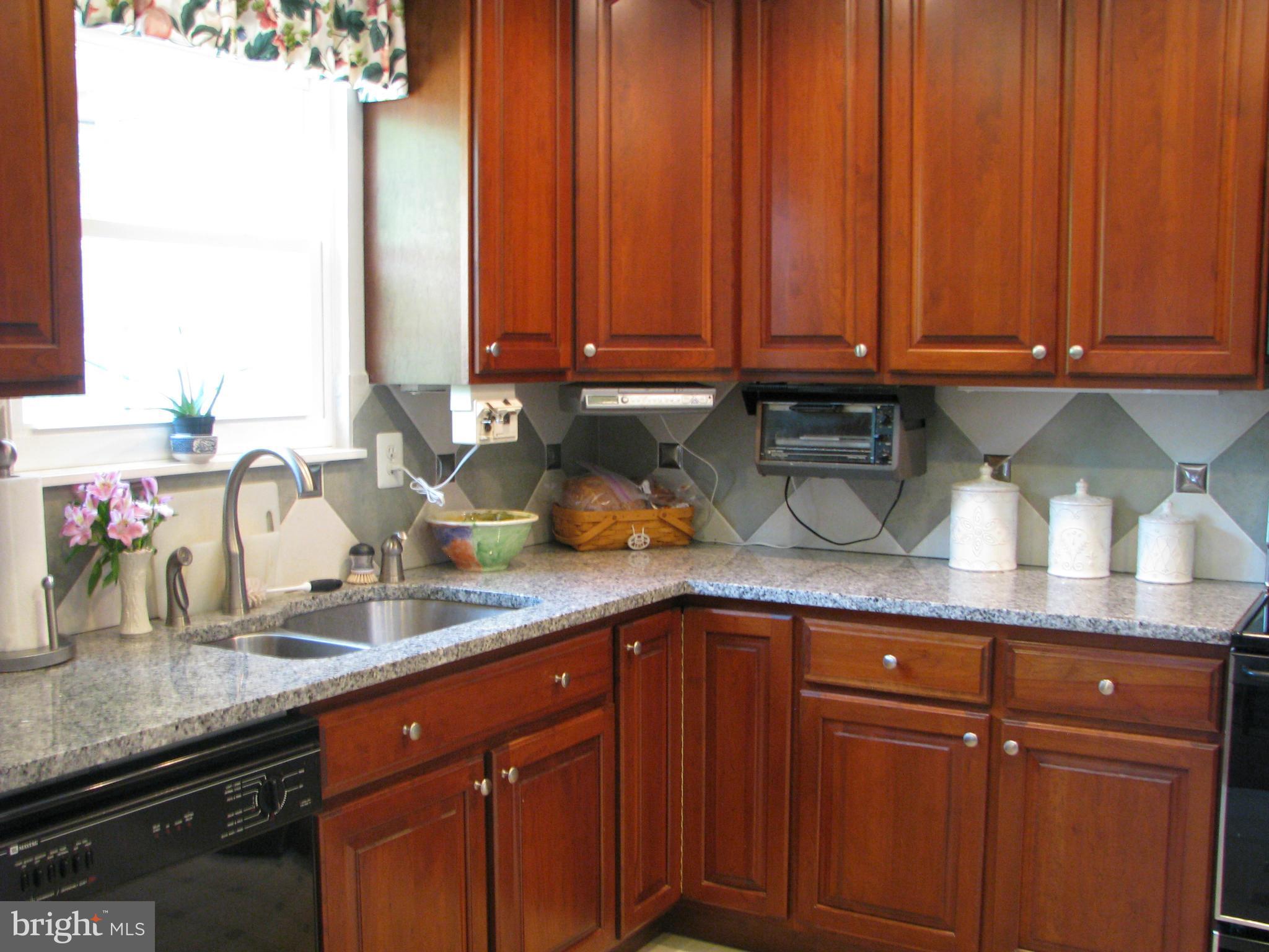 4207 Jackson Mill Road Haymarket, VA 20169 - Photo 5 of 30 a kitchen with stainless steel appliances granite countertop a sink dishwasher stove and cabinets