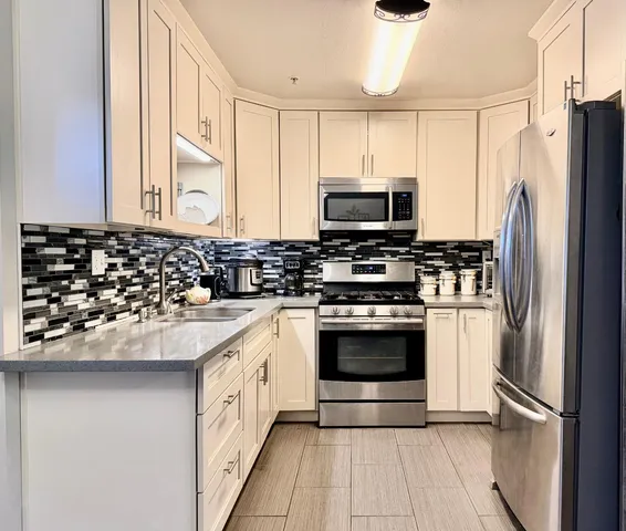 a kitchen with a sink stove and refrigerator