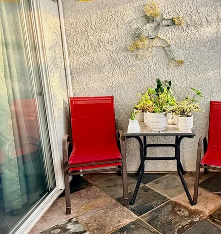 a view of a backyard with plants and outdoor seating