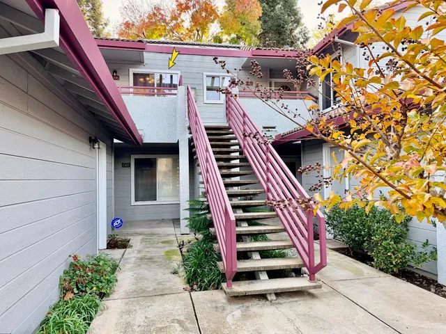 a view of a house with a tree in a park