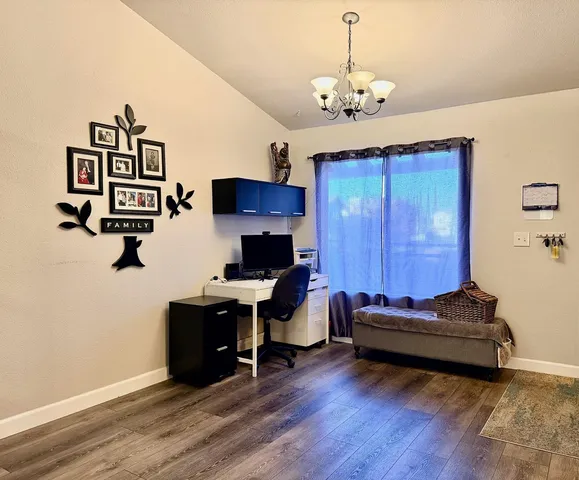 a view of a workspace with furniture and a chandelier