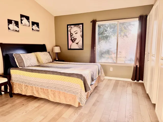 a bedroom with a large bed and a large window