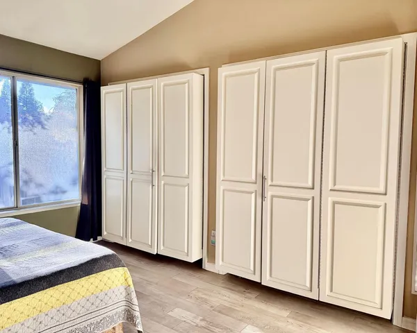 a bedroom with a bed and a window