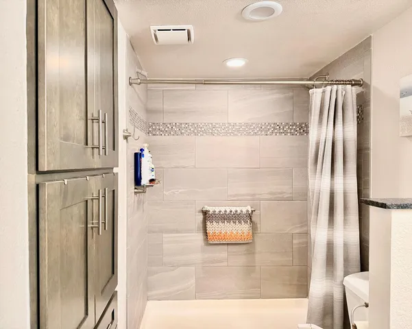 a bathroom with a shower and a mirror