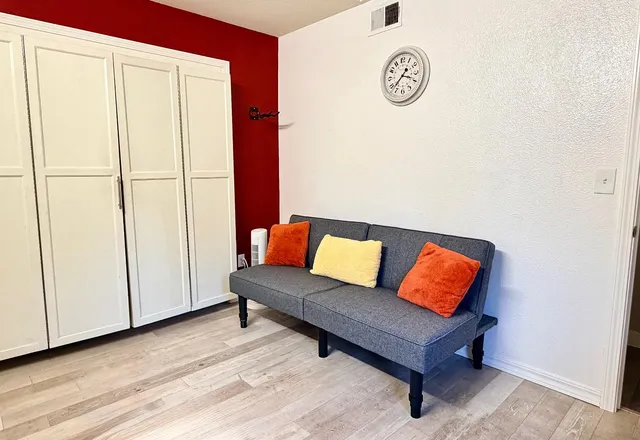 a living room with furniture and a white walls