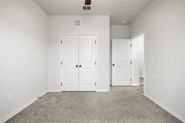 an empty room with closet area