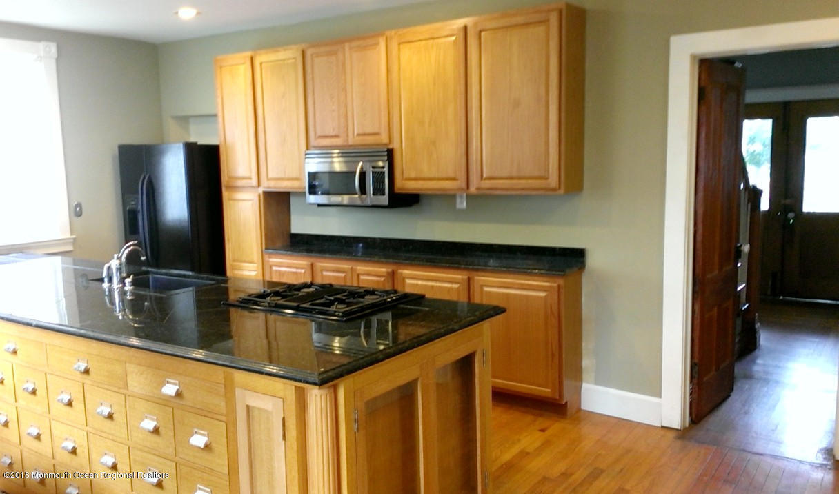 80 Elizabeth Street Keyport, NJ 07735 - Photo 2 of 6 a kitchen with stainless steel appliances granite countertop a stove a sink and a microwave