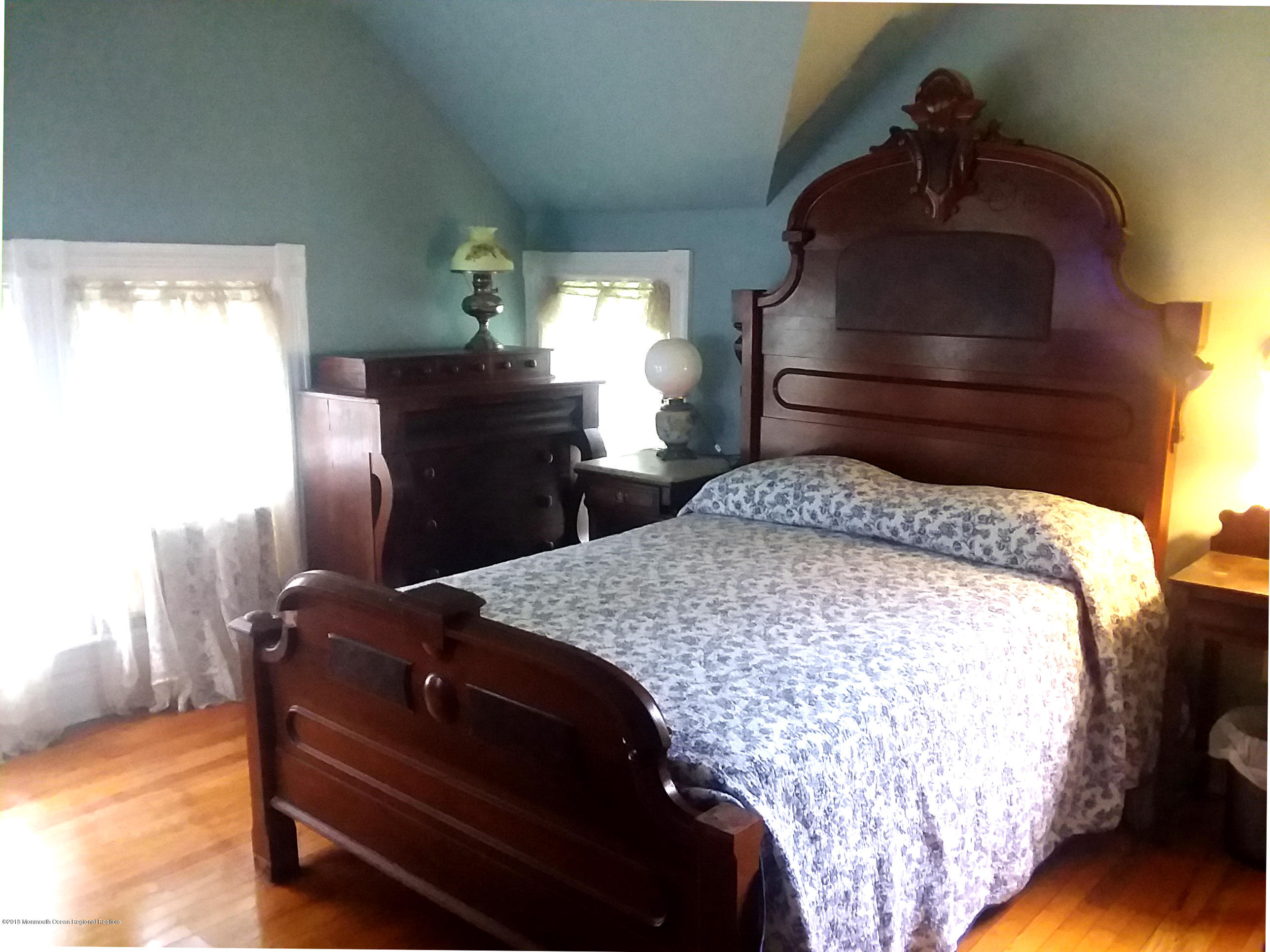 80 Elizabeth Street Keyport, NJ 07735 - Photo 5 of 6 a bedroom with a bed and wooden floor