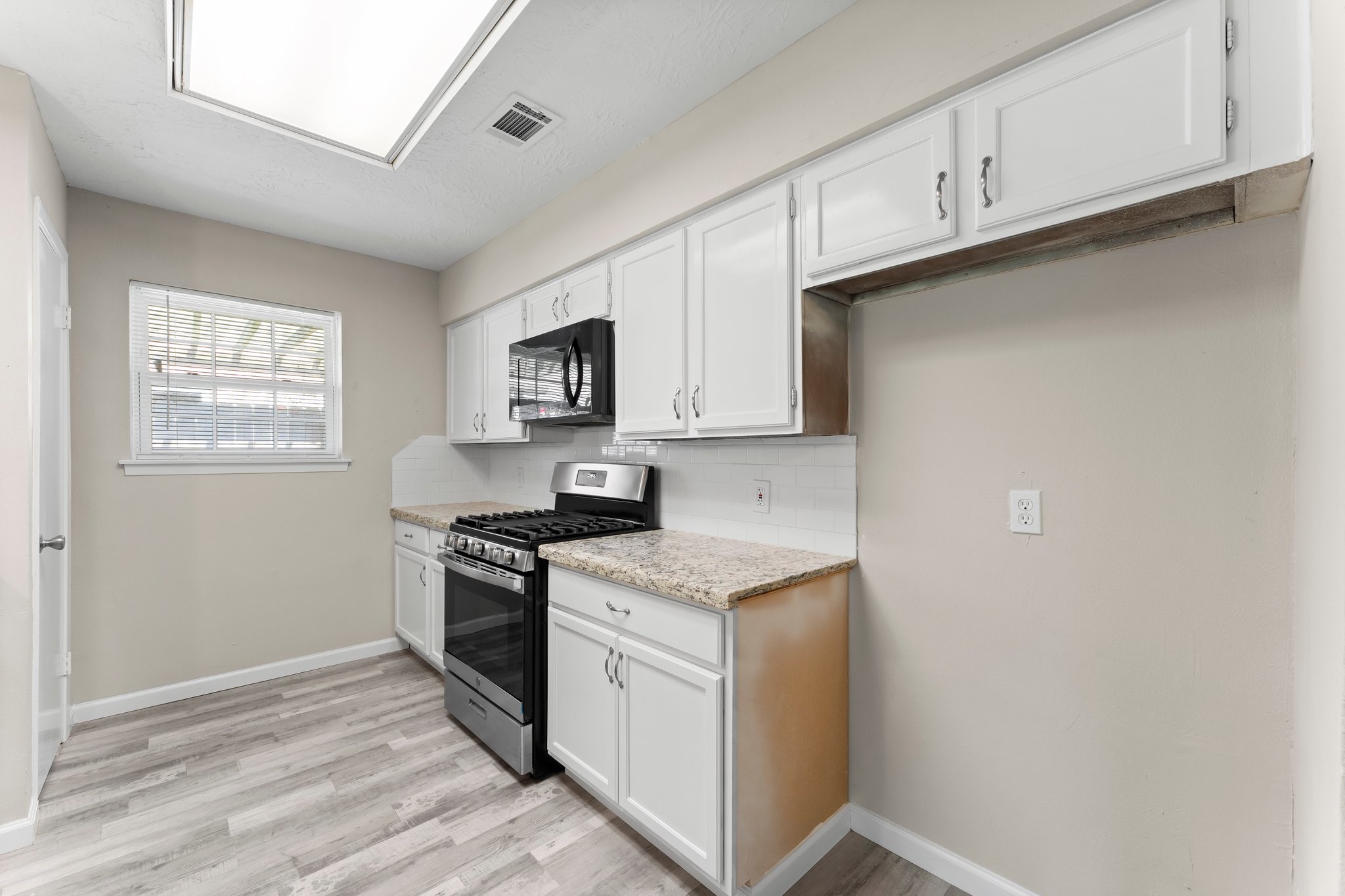3527 Acorn Way Lane Spring, TX 77389 - Photo 8 of 26 a kitchen with stainless steel appliances granite countertop white cabinets and window