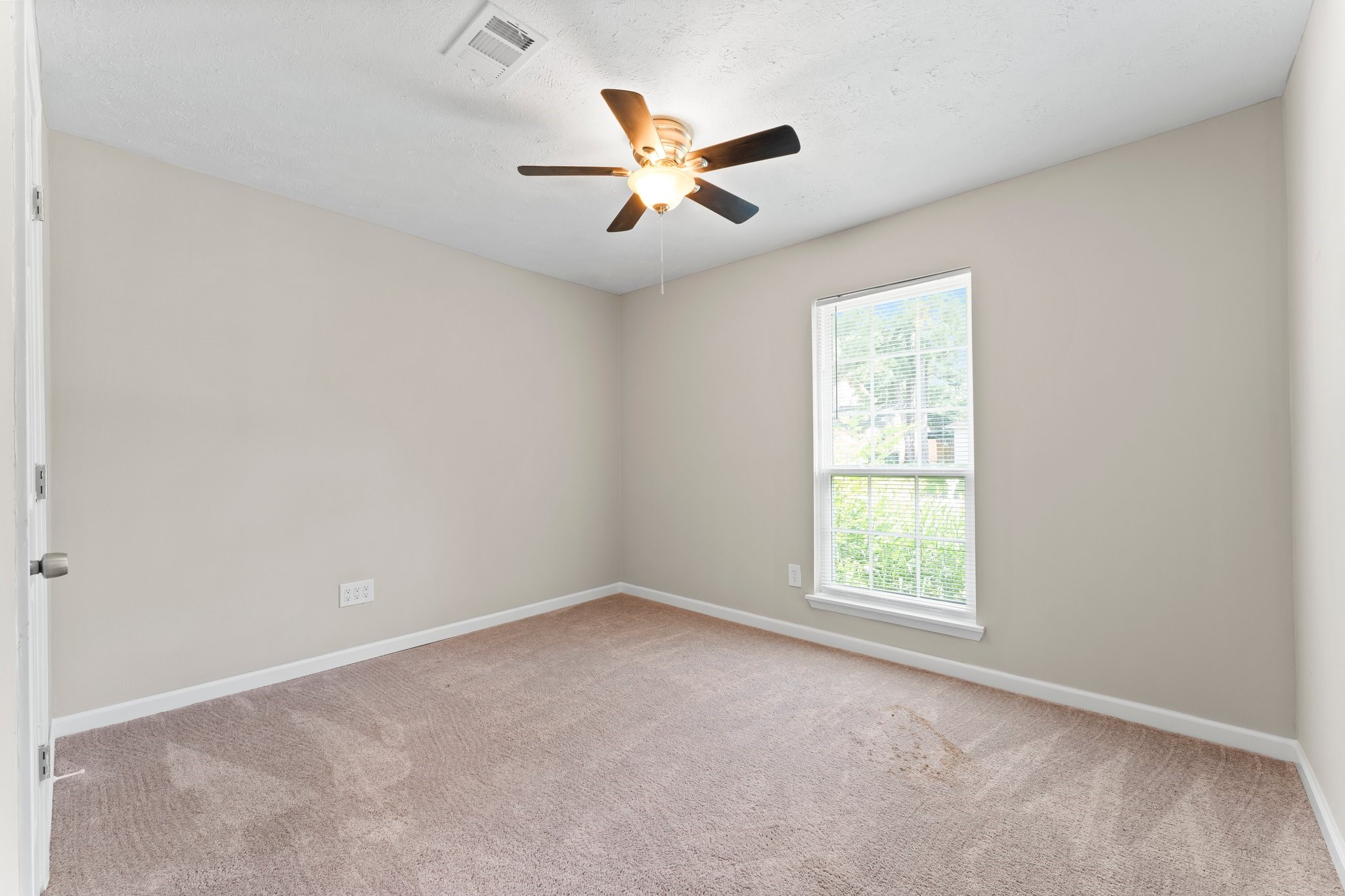 3527 Acorn Way Lane Spring, TX 77389 - Photo 9 of 26 an empty room with a window and a fan