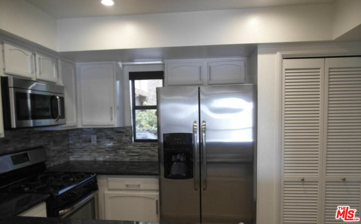 2480 Penmar Avenue, Unit 2 Venice, CA 90291 - Photo 4 of 8 a kitchen with a refrigerator and a stove top oven