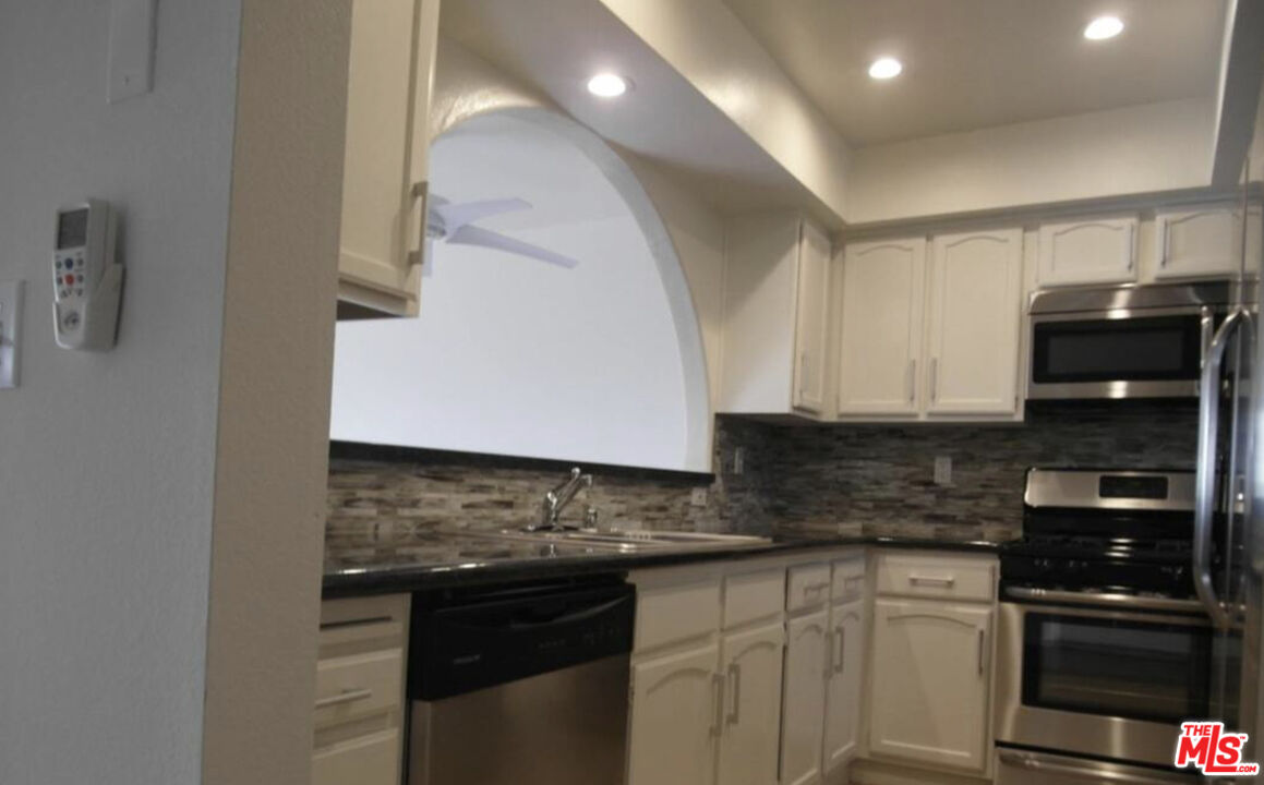 2480 Penmar Avenue, Unit 2 Venice, CA 90291 - Photo 5 of 8 a kitchen with stainless steel appliances granite countertop a stove and a sink