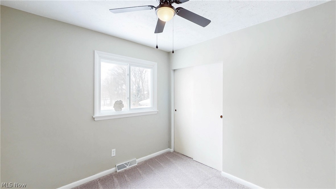 3312 Bancroft Road Akron, OH 44333 - Photo 29 of 50 Unfurnished room featuring light colored carpet and a ceiling fan