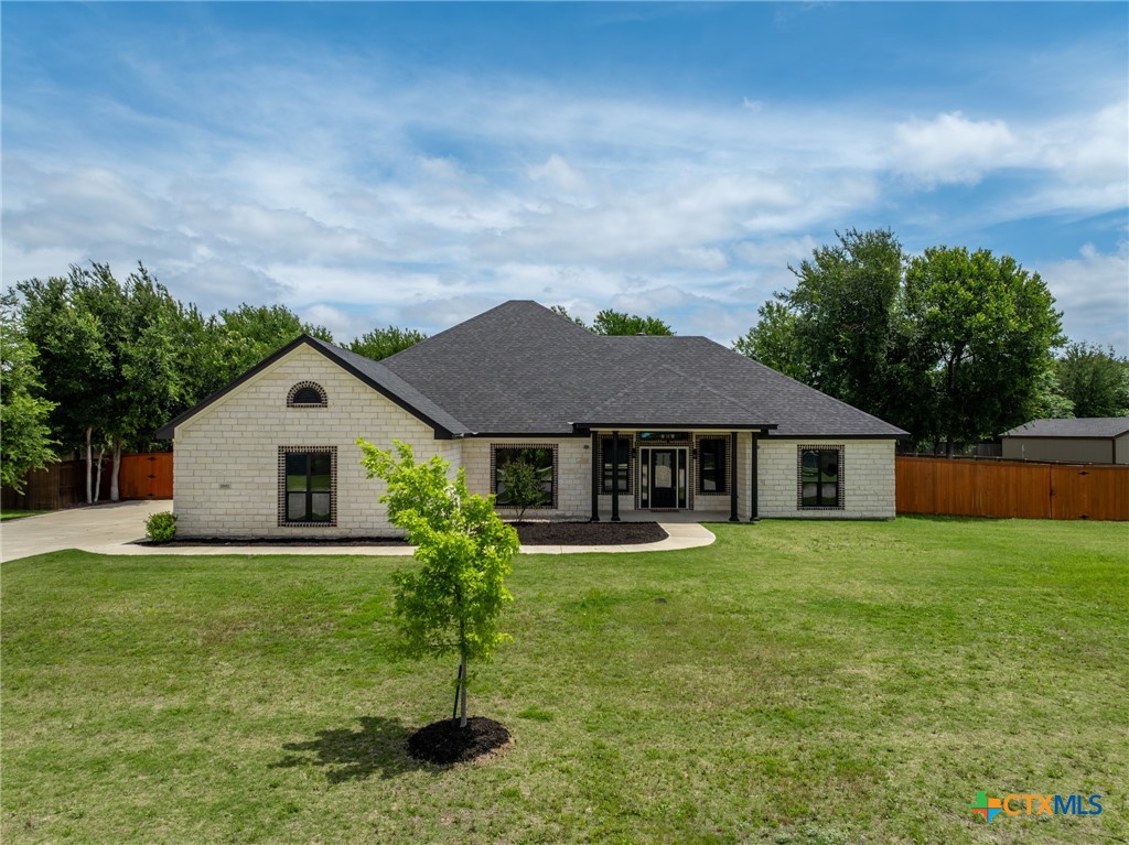 a big house with a big yard and more large trees