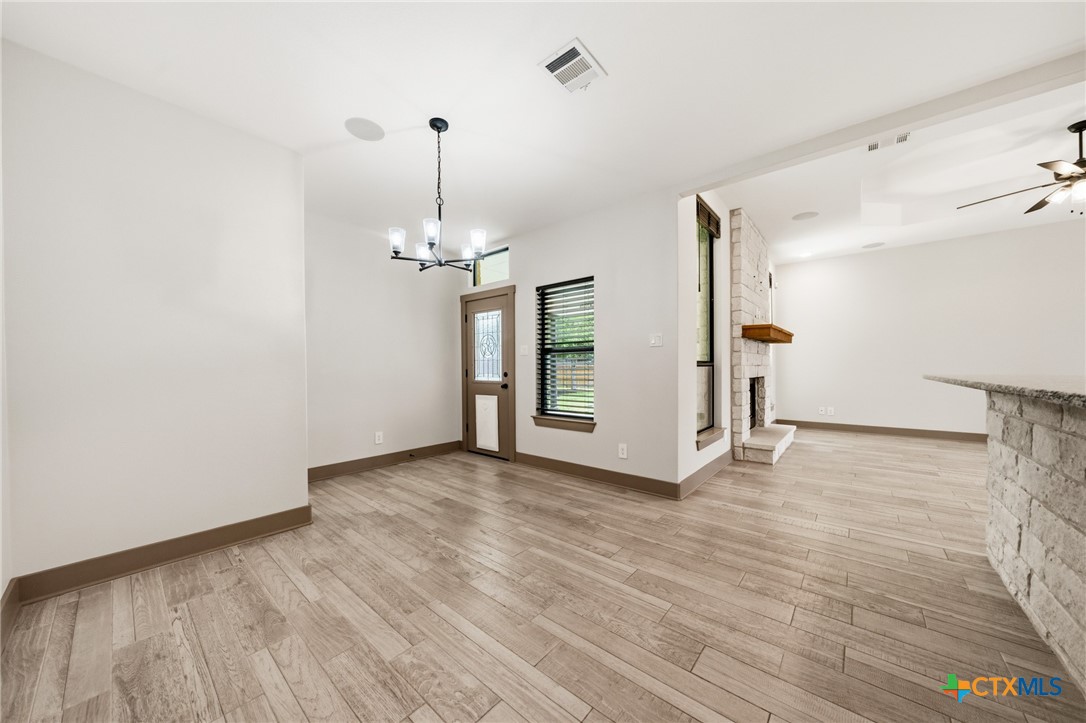 2892 Beulah Boulevard Belton, TX 76513 - Photo 12 of 47 a view of a room with wooden floor chandelier and windows