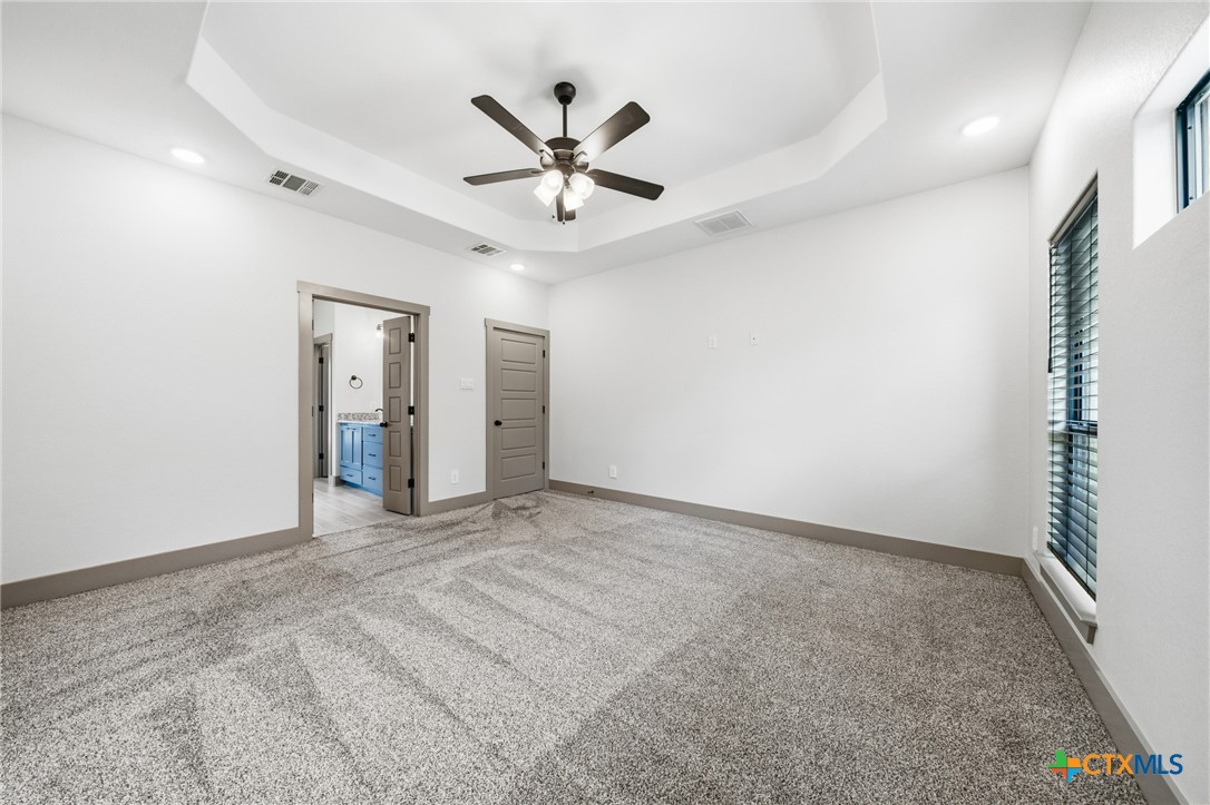 2892 Beulah Boulevard Belton, TX 76513 - Photo 14 of 47 an empty room with chandelier fan and windows