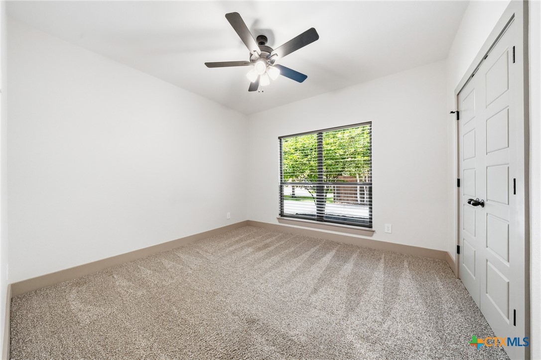 2892 Beulah Boulevard Belton, TX 76513 - Photo 21 of 47 an empty room with ceiling fan and window