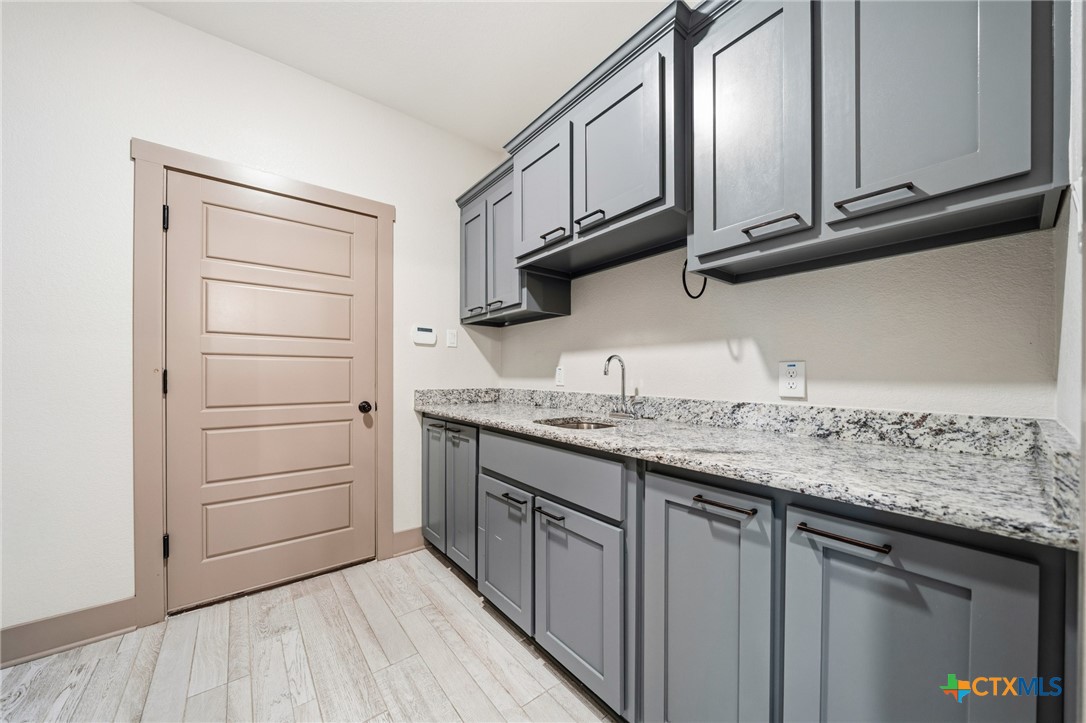 2892 Beulah Boulevard Belton, TX 76513 - Photo 28 of 47 a kitchen with stainless steel appliances granite countertop a sink and dishwasher stove with cabinets