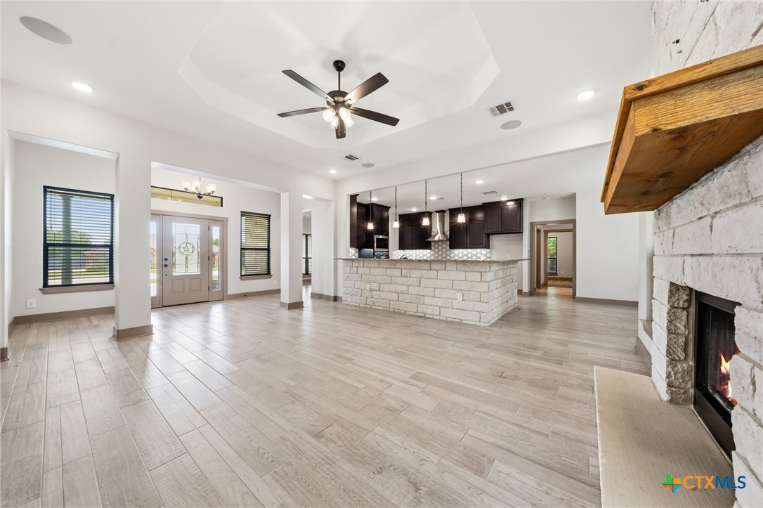 2892 Beulah Boulevard Belton, TX 76513 - Photo 6 of 47 a view of an empty room with wooden floor and a kitchen