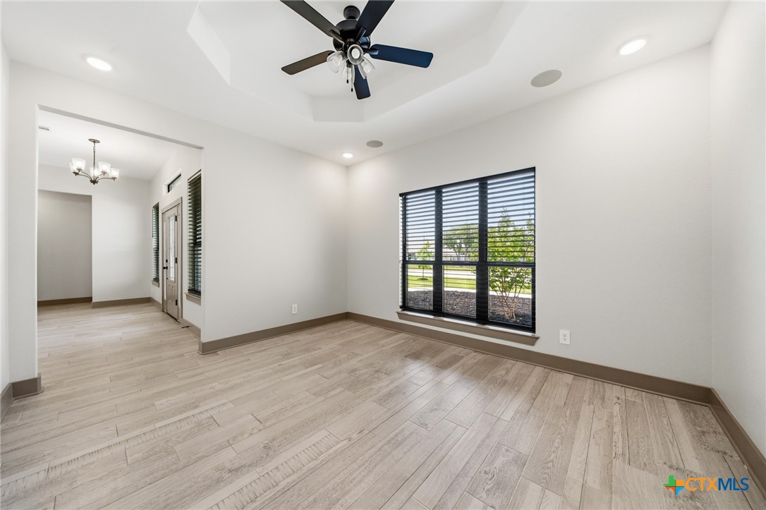 2892 Beulah Boulevard Belton, TX 76513 - Photo 7 of 47 a view of an empty room with a window and wooden floor