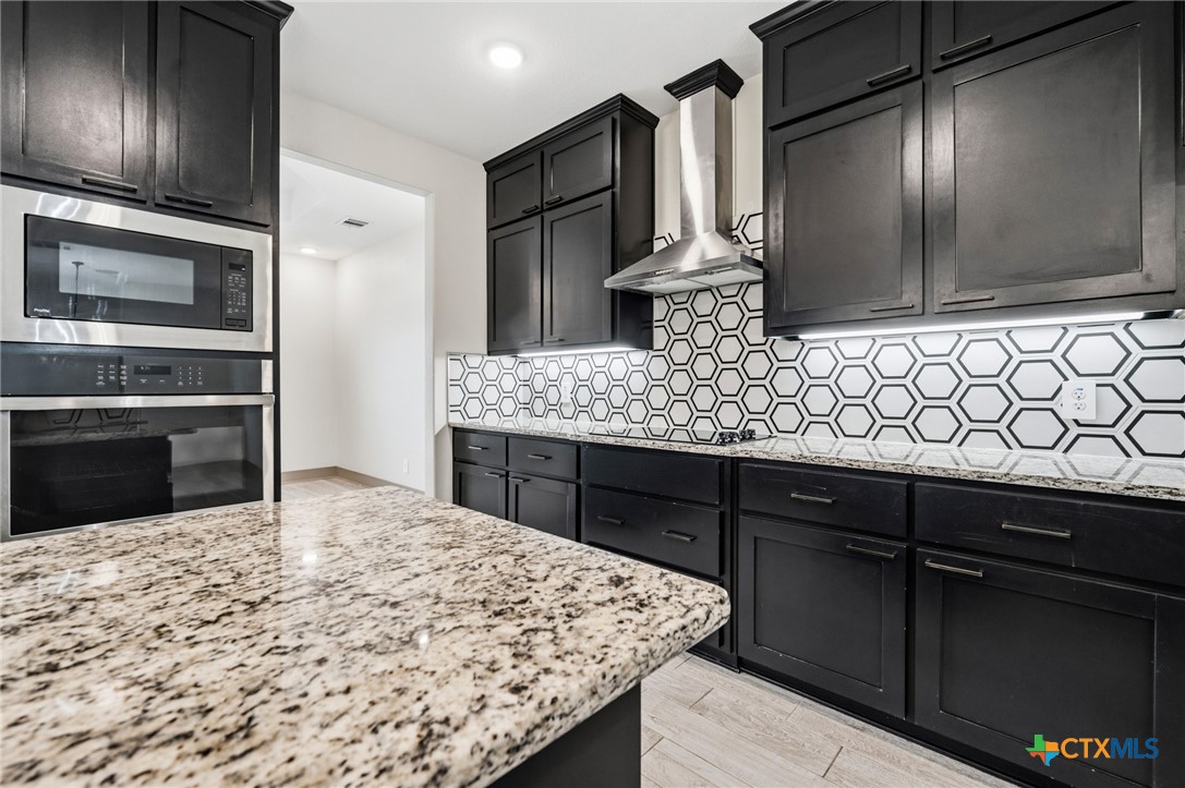 2892 Beulah Boulevard Belton, TX 76513 - Photo 10 of 47 a kitchen with stainless steel appliances kitchen island granite countertop a sink stove and refrigerator