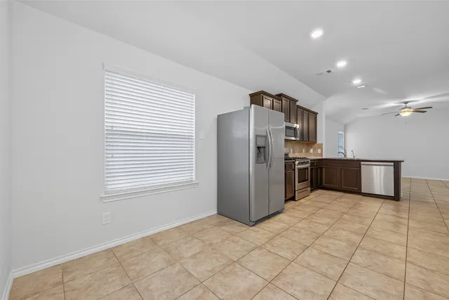 a kitchen with stainless steel appliances a refrigerator and a sink