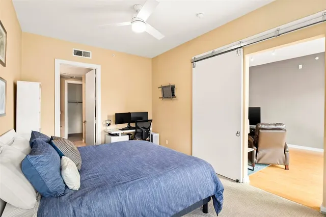 a bedroom with a bed and a chair