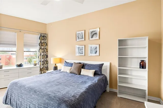 a bedroom with a large bed and a large window