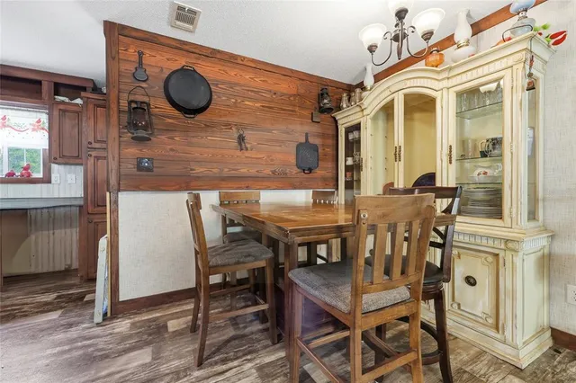 a dining room with a wooden table and chairs