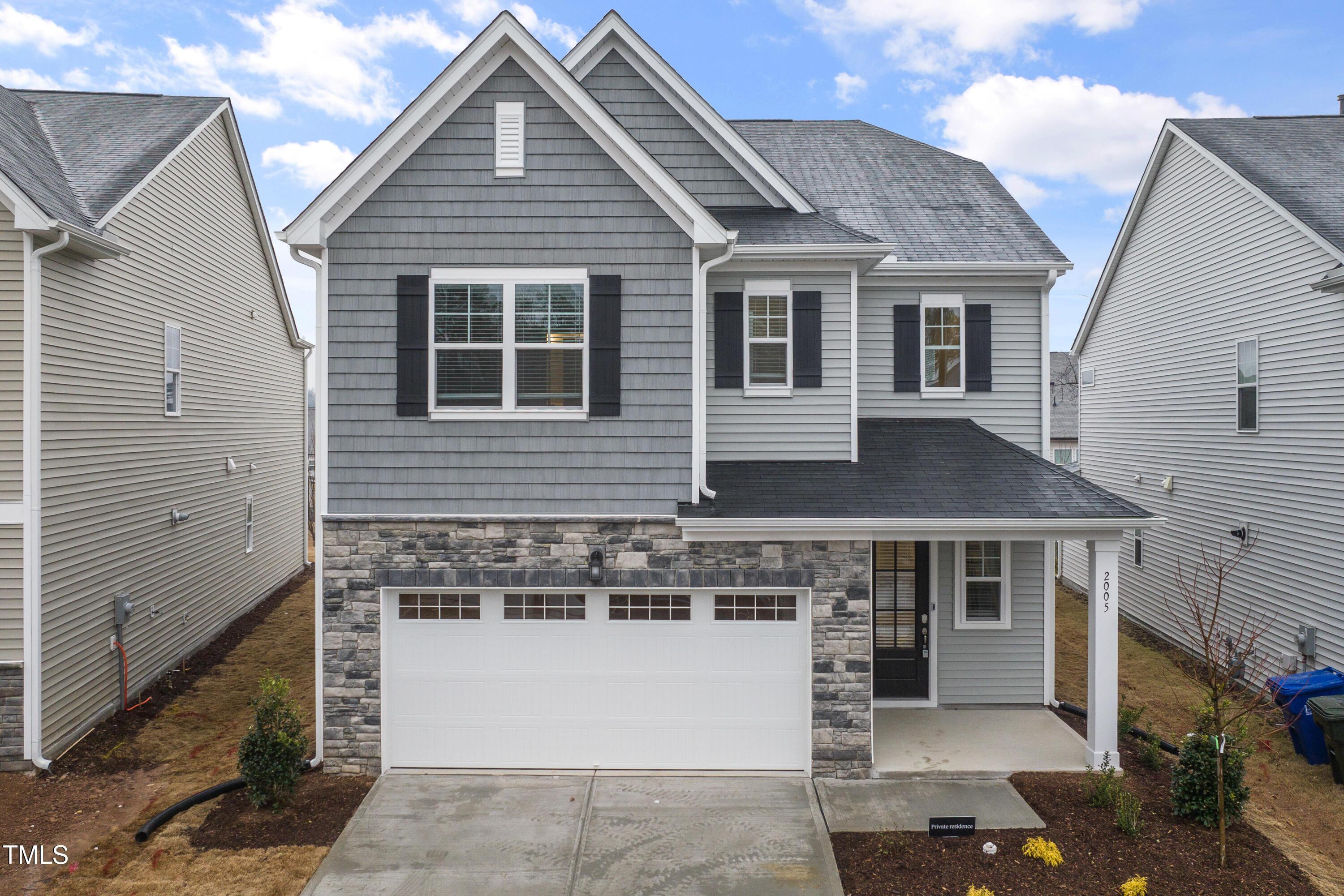 2005 Mavin Place Durham, NC 27703 - Photo 1 of 26 a front view of a house with a garage