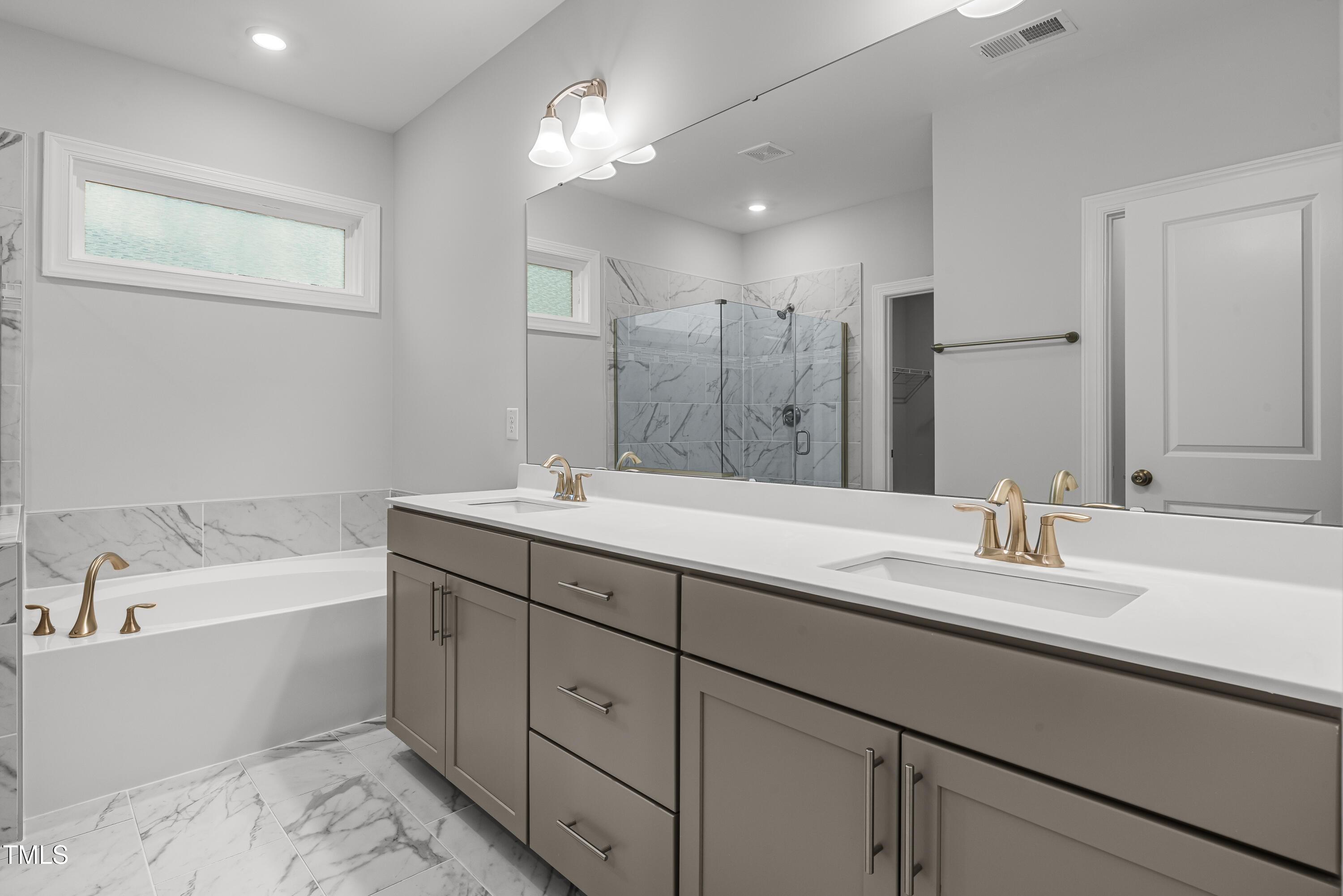 2005 Mavin Place Durham, NC 27703 - Photo 13 of 26 a bathroom with a sink double vanity granite tub and a mirror