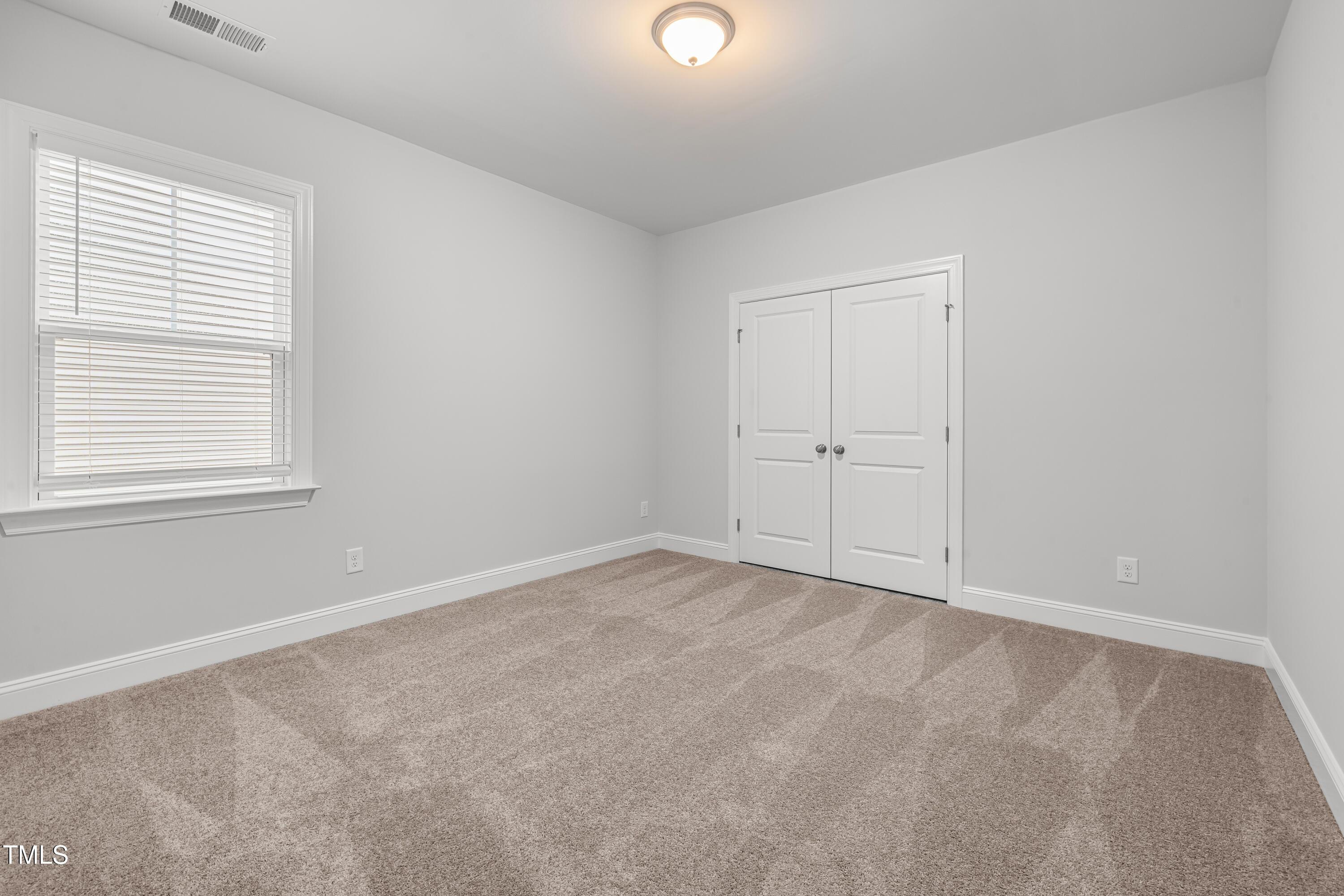 2005 Mavin Place Durham, NC 27703 - Photo 18 of 26 an empty room with white cabinet and windows