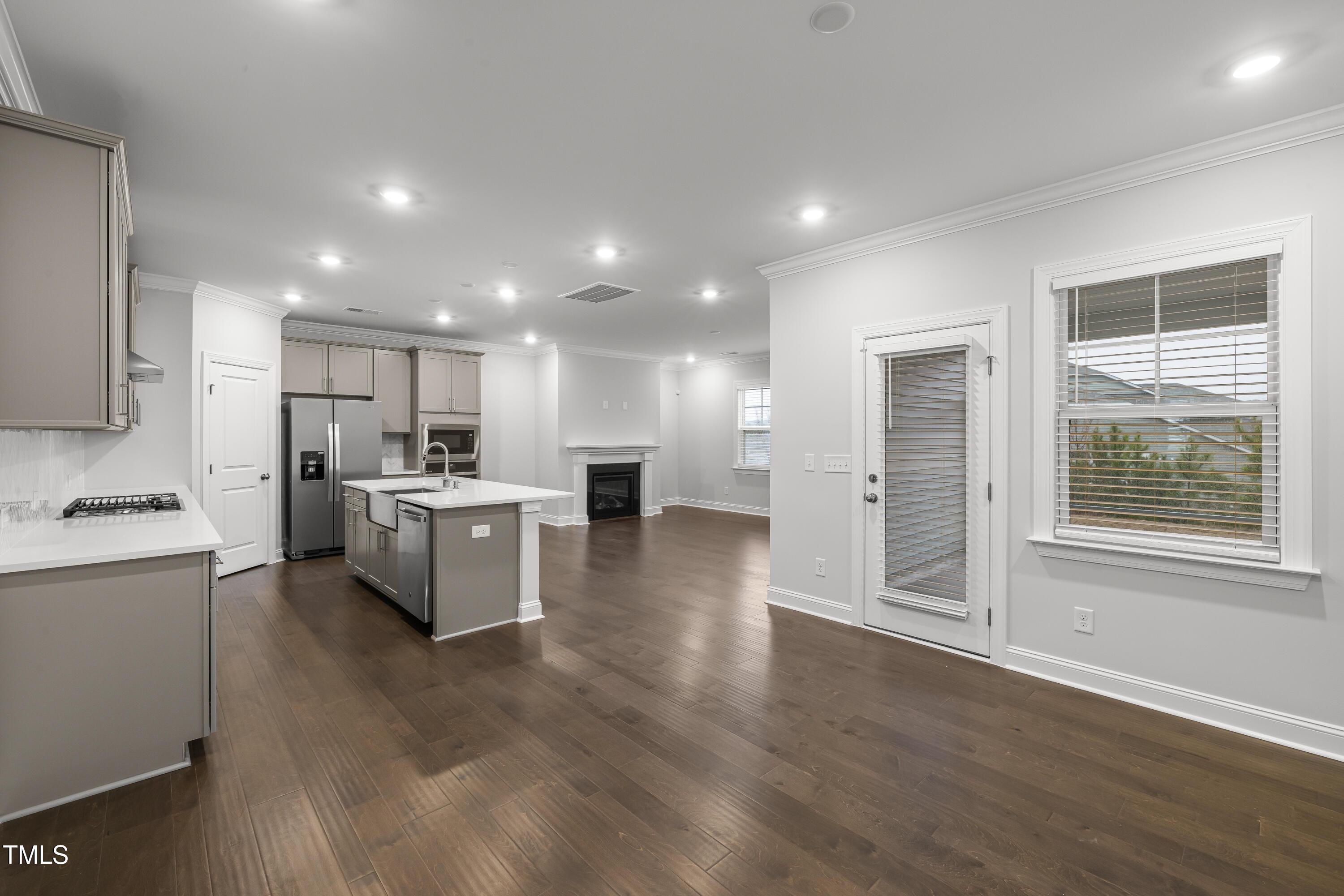2005 Mavin Place Durham, NC 27703 - Photo 3 of 26 a kitchen with kitchen island white cabinets and stainless steel appliances