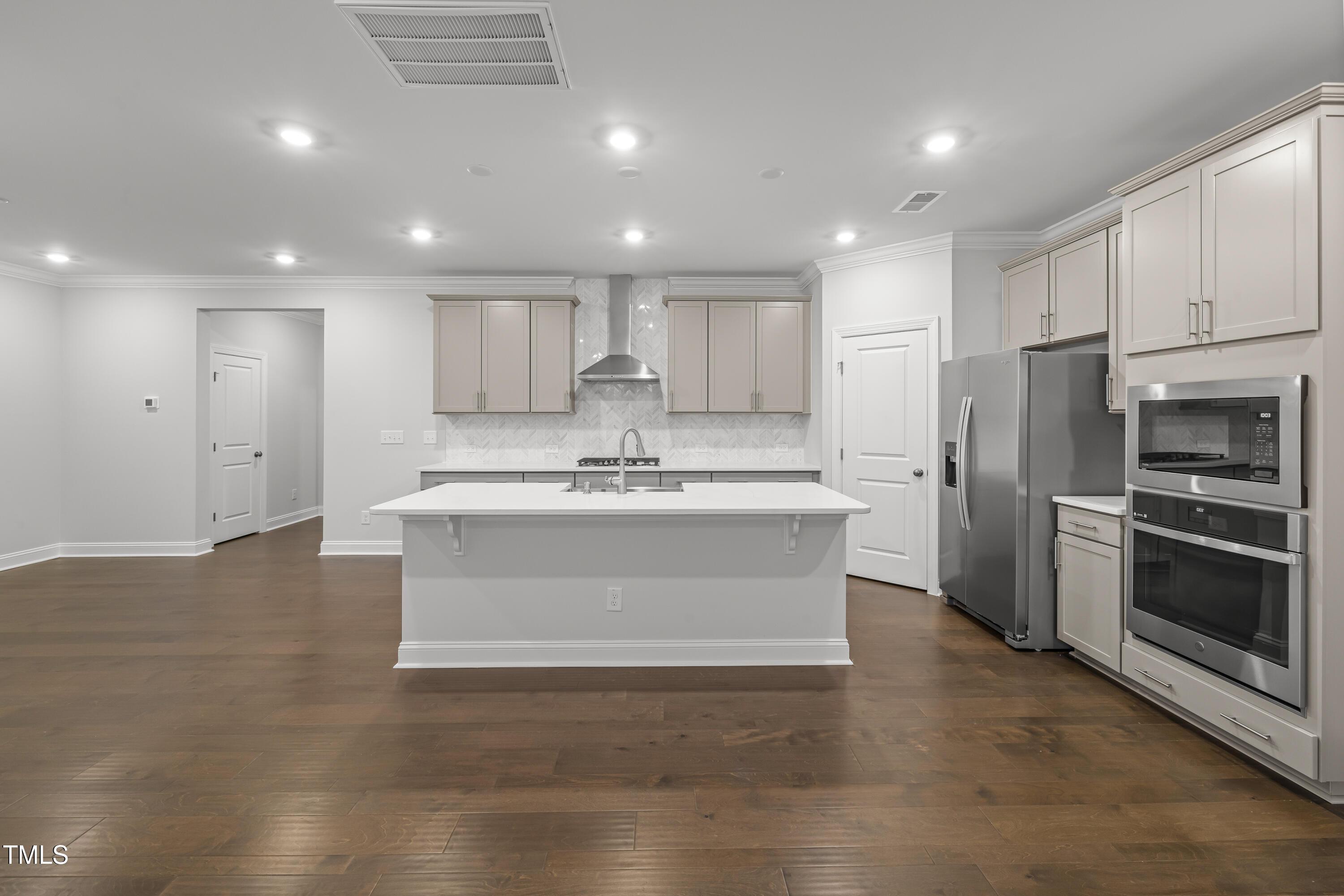 2005 Mavin Place Durham, NC 27703 - Photo 6 of 26 a large kitchen with kitchen island a sink stainless steel appliances and cabinets